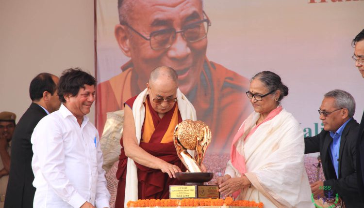 His Holiness The Dalai Lama receiving the KISS Humanitarian Award in the presence of esteemed dignitaries